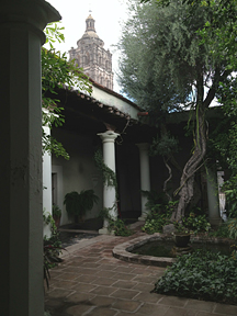 [Church bell tower from the garden patio of a residence on the Plaza.: 180k]