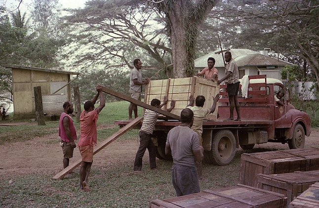 [crew of 8 men lever/hoist up large wooden cases into flatbed truck: 197k]