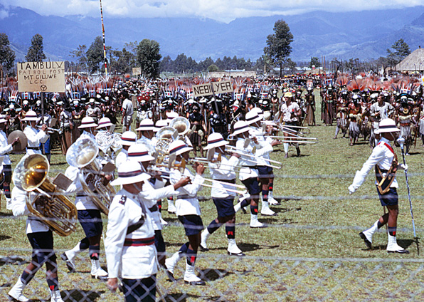 [Band master leads the band clad all in  white with matching helmets, tuba player on the left: 369k]